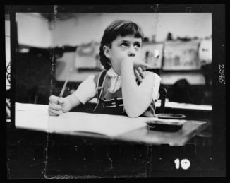8-Young-girl-seated-at-desk-in-classroom-in-Chicago-Illinois-520x414